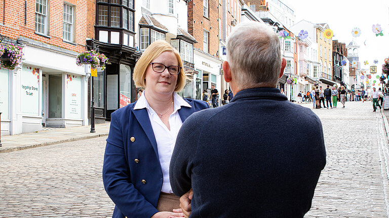 Zöe Franklin MP listening to a resident